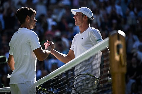 Winner Spain's Carlos Alcaraz (left) congratulates Britain's Oliver Tarvet at the end of their men's singles second round tennis match on the third day of the 2025 Wimbledon Championships at The All England Lawn Tennis and Croquet Club in Wimbledon, southwest London, on July 2, 2025.
