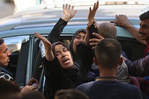 Palestinians mourn at Al Shifa hospital in Gaza City, where the victims of an Israeli strike which hit the Mustafa Hafez school, sheltering Palestinians displaced by the war, were brought, on July 3, 2025, amid the ongoing conflict between Israel and the Palestinian Hamas militant group.