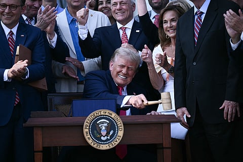 US President Donald Trump (C) bangs a gavel after signing the "Big Beautiful Bill Act" at the White House in Washington, DC, on July 4, 2025.
