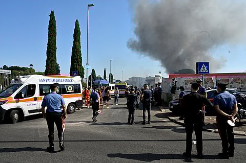 Firemen, policemen and rescue teams work on the site of an explosion in a fuel station in Rome on July 4, 2025.