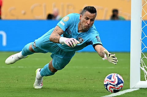 Fluminense's Brazilian goalkeeper Fabio dives to stop a ball during the Fifa Club World Cup 2025 quarter-final football match against Saudi Arabia's Al Hilal at the Camping World Stadium in Orlando on July 4, 2025.