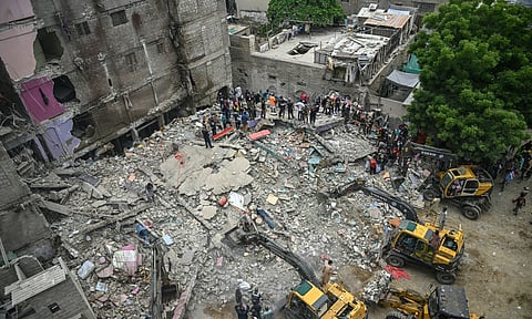 At least 23 residents are reported killed in a building collapse in Karachi.