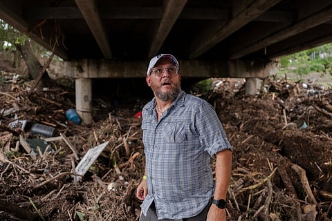 Joe Treadaway searches for survivors after flash flooding on the bank Guadalupe River on July 5, 2025 in Center Point, Texas.