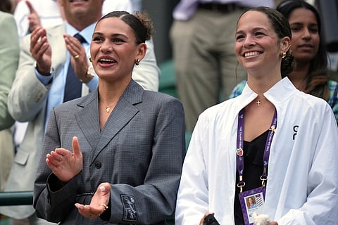 Shelton's girlfriend, US football player Trinity Rodman, and his sister Emma applaud after Ben Shelton of the U.S. won his men's singles third round match against Marton Fucsovics of Hungary at the Wimbledon Tennis Championships in London, Saturday, July 5, 2025.