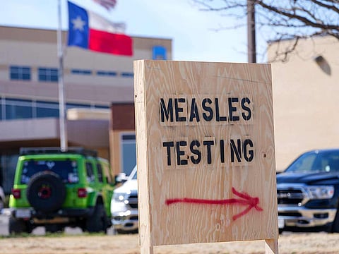 File photo: A sign is displayed outside the Seminole Hospital District offering measles testing, in Seminole, Texas.