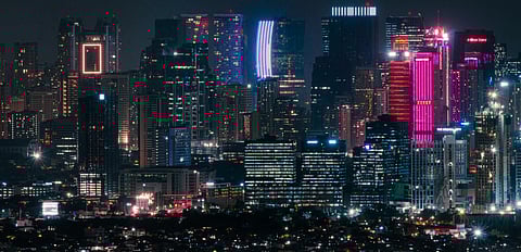 A night-time view of Manila skyscrapers. Despite a rise from $4,320 in 2023 to $4,470 in 2024 in gross national income (GNI) per capita, the Philippines was $26 short of the minimum upper middle income status threshold of $4,496.