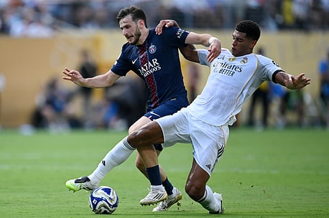 Paris Saint-Germain's Georgian forward Khvicha Kvaratskhelia and Real Madrid's English midfielder Jude Bellingham fight for the ball during the Fifa Club World Cup 2025 semi-final football match at the MetLife stadium in East Rutherford, New Jersey on July 9, 2025.