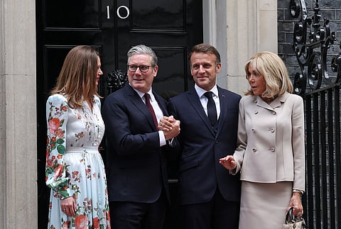 Britain's Prime Minister Keir Starmer and his wife Victoria Starmer welcome France's President Emmanuel Macron and his wife Brigitte Macron upon their arrival for lunch and bilateral meetings at 10 Downing Street in London, on July 9, 2025, on the second day of a three-day state visit to Britain.