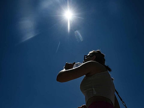 A tourist drinks water during a heatwave in Thessaloniki, Greece.