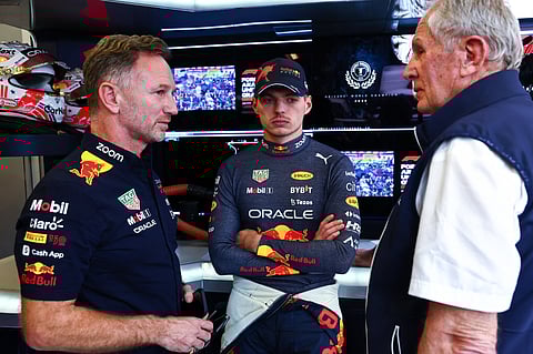 Max Verstappen of the Netherlands and Oracle Red Bull Racing (C) talks with Red Bull Racing Team Principal Christian Horner (L) and Red Bull Racing Team Consultant Dr Helmut Marko (R) in the garage during qualifying ahead of the F1 Grand Prix of USA at Circuit of The Americas on October 22, 2022 in Austin, Texas.