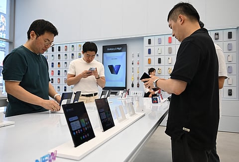 Visitors get a look at the Samsung Galaxy Z Fold7 smartphone at a Samsung store in Seoul on July 10, 2025.