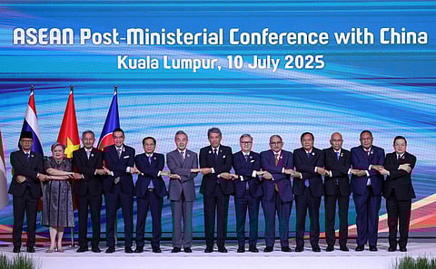 Indonesia's Minister for Foreign Affairs Sugiono, Philippines' Secretary of Foreign Affairs Theresa Lazaro, Singapore's Minister for Foreign Affairs Vivian Balakrishnan, Thailand's Minister of Foreign Affairs Maris Sangiampongsa, Vietnam's Minister of Foreign Affairs Bui Thanh Son, China's Foreign Minister Wang Yi, Malaysia's Minister of Foreign Affairs Mohamad Hasan, Laos' Minister of Foreign Affairs Thongsavanh Phomvihane, Brunei's Second Minister of Foreign Affairs Erywan Yusof, Cambodia's Minister of Foreign Affairs Prak Sokhonn, Myanmar's Acting Permanent Secretary of the Ministry of Foreign Affairs Kyaw Nyun Oo, Timor-Leste's Minister of Foreign Affairs Bendito dos Santos Freitas and Secretary General of the ASEAN Kao Kim Hourn pose for a group photo as they attend the Association of Southeast Asian Nations (ASEAN) Post-Ministerial Conference with China during the 58th ASEAN Foreign Ministers’ meeting and related meetings at the Convention Centre in Kuala Lumpur on July 10, 2025.