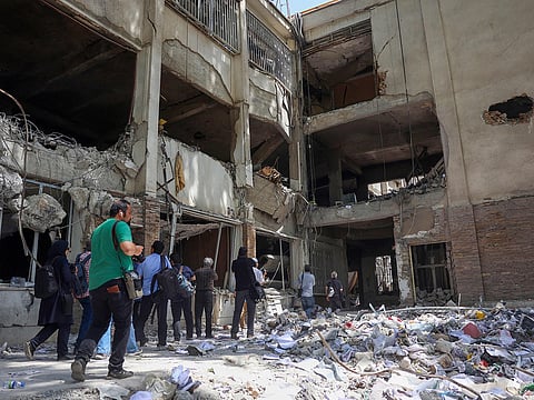 People walk amid debris at the Evin prison after Israeli air strikes the previous month, in Tehran, on July 1, 2025. Lessons from Europe challenge us to imagine a region where shared prosperity replaces mutual suspicion.