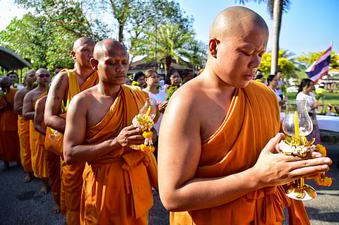 Buddhist monks pray during an event to mark Asalha Bucha Day in the southern Thai town of Narathiwat on July 10, 2025.