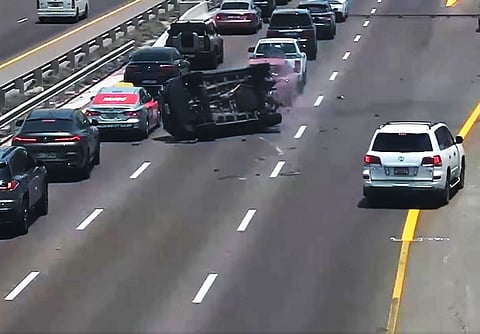 The black SUV crashes into a car in the adjacent lane, causing it to turn over on its side