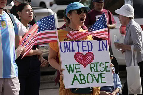 Immigration advocates protest recent detentions by ICE outside the immigration court in San Antonio, Texas, Tuesday, July 1, 2025. (AP Photo/Eric Gay)