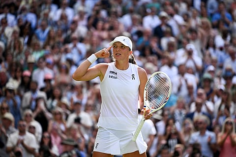 Poland's Iga Swiatek celebrates after winning against US player Amanda Anisimova during their women's singles final tennis match on the thirteenth day of the 2025 Wimbledon Championships at The All England Lawn Tennis and Croquet Club in Wimbledon, southwest London, on July 12, 2025.