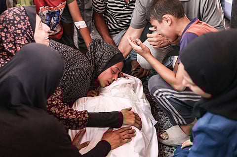 Palestinians mourn a relative killed in an Israeli strike, in Gaza City's Maamadani (Baptist) hospital on July 13, 2025.