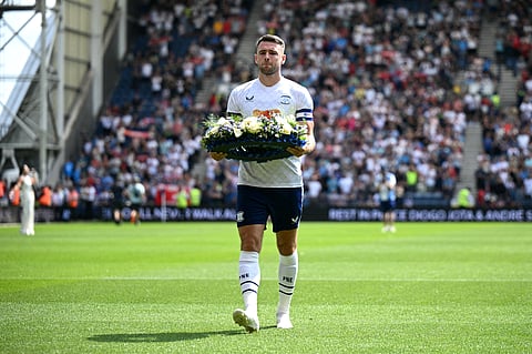 Preston's English midfielder Ben Whiteman lays a wreath for Liverpool's late Portuguese striker Diogo Jota during the pre-season friendly football match between Preston North End and Liverpool at Deepdale stadium in Preston, north-west England on July 13, 2025.