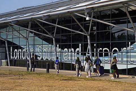 Passengers outside the terminal building at Southend Airport in Essex, where a 12-metre plane crashed shortly after take off on Sunday afternoon, Monday, July 14, 2025.