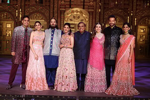(L to R) Akash Ambani, Shloka Ambani, Anant Ambani, Radhika Ambani, Mukesh Ambani, Nita Ambani, Anand Piramal, and Isha Ambani.