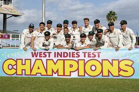 Australia's players pose with the trophy after winning on the third day of the third Test cricket match between West Indies and Australia at Sabina Park in Kingston, Jamaica, on July 14, 2025.