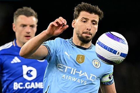Manchester City's Ruben Dias (right) focuses on the ball during an English Premier League football match. The Portuguese defender has extended his stay at Etihad for another four years.