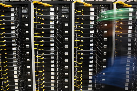 A worker walks past crypto mining racks at a plant in Hernandarias, 350km east of Asuncion, Paraguay on August 2, 2024.