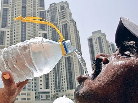A worker tries to beat the summer heat at a construction site in Dubai.