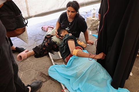 Palestinians who were injured in an Israeli strike on the Holy Family church receive treatment in Gaza City's Arab Ahli, also known as Baptist, hospital in Gaza City on July 17, 2025.