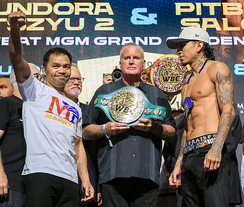 TGB Promotions President Tom Brown (C) looks on as Manny Pacquiao (L) and WBC welterweight champion Mario Barrios (R) attend a ceremonial weigh-in.