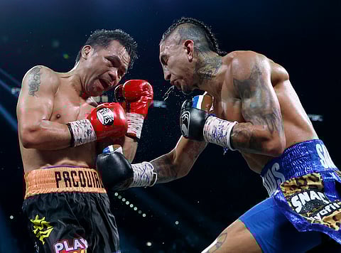 Mario Barrios (R) punches Manny Pacquiao during their WBC welterweight title fight ending in a majority draw at MGM Grand Garden Arena in Las Vegas, Nevada.