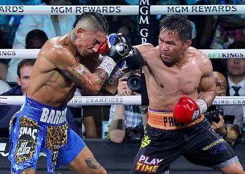 Manny Pacquiao throws a right at Mario Barrios in the seventh round of their WBC welterweight title fight at MGM Grand Garden Arena on July 19, 2025 in Las Vegas, Nevada.