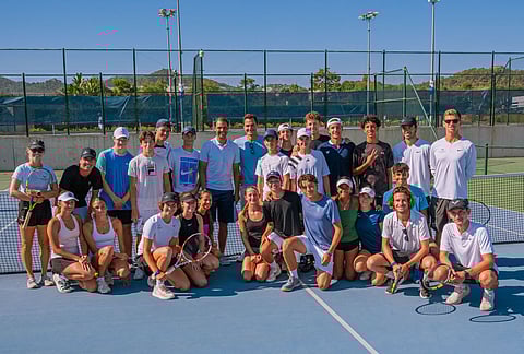 Myla and Charlene (far left sitting) with a group of tennis players at the Rafael Nadal Academy.