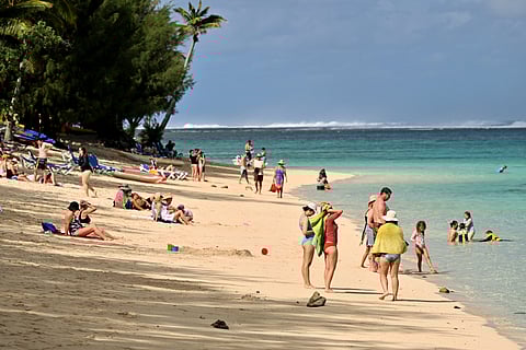 Tourists relax at a resort on Rarotonga, the largest island of the Cook Islands on June 12, 2025.
