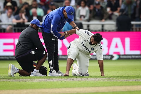 India's Rishabh Pant reacts as he receives medical attention following a foot injury while playing on day one of the fourth Test against England at Old Trafford.