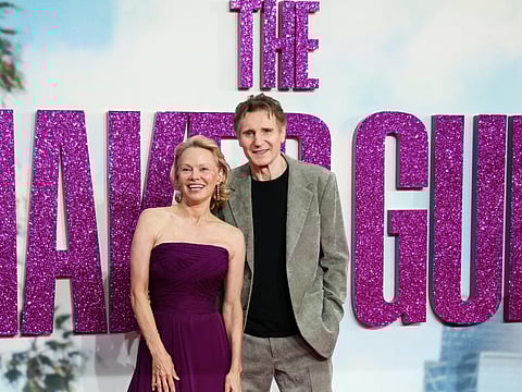 Pamela Anderson (L) and British actor Liam Neeson (R) pose on the red carpet upon arrival for the UK Premier of "Naked Gun" in Leicester Square, central London, on July 22, 2025.