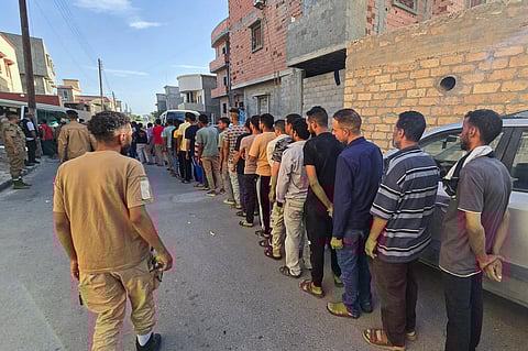 Members of Libya's Anti-Illegal Immigration Agency round up unregistered migrants from a housing unit in Tripoli early on July 26, 2025.. Photo for illustrative purpose only