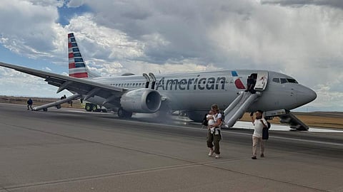 Smoke and panic on runway: American Airlines flight evacuated after landing gear bursts into flames