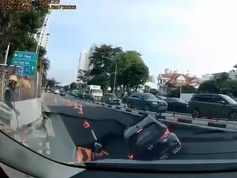Dashcam footage shows the road suddenly caving in, creating a deep hole that trapped a vehicle.