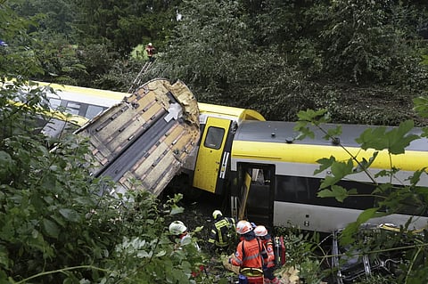 Rescue workers search for passengers in a derailed train, Zwiefaltendorf, Sunday July 27, 2025.