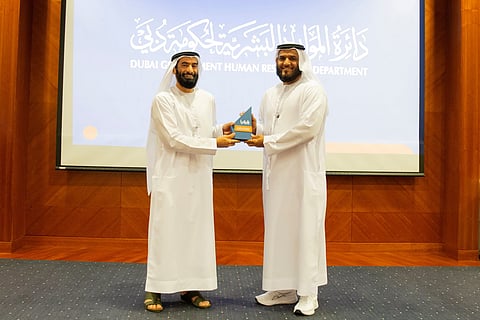 Abdullah Ali Bin Zayed Al Falasi (left) honours Dr Mohammed Suhail Al Muhairi.