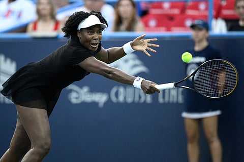 Venus Williams lunges for the ball during a match against Magdalena Frech, of Poland, at the Citi Open tennis tournament Thursday, July 24, 2025.