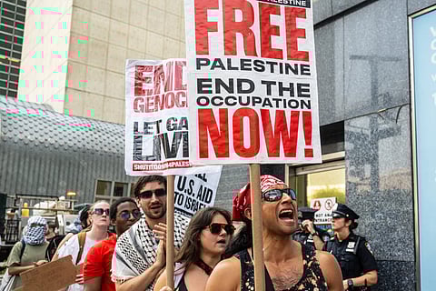 People participate in a protest in support of Palestine outside the UN as a conference on Palestine and a two-state solution takes place inside the UN on July 29, 2025 in New York City.