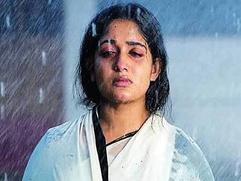 Kavya Madhavan plays the grieving widow Ganga in Perumuzhakkalam