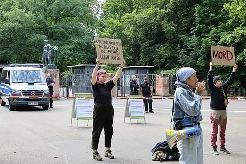 Demonstrators stand with protest signs in front of the Nuremberg Zoo in Nuremberg, Germany, Tuesday, July 29, 2025. Slogan reads 'we won't remain silence until all animals can live in freedom'. (Daniel Loeb/dpa via AP)