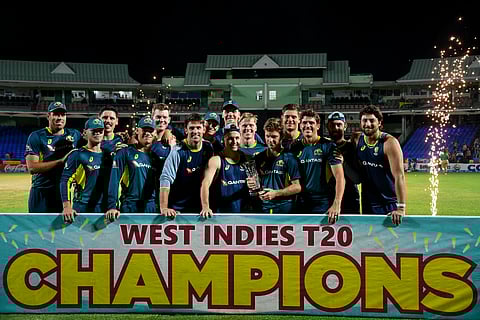 Australia's players celebrate with the trophy at the end of the fifth and final Twenty20 (T20) international cricket match between West Indies and Australia at Warner Park Sporting Complex in Basseterre, Saint Kitts and Nevis, on July 28, 2025.