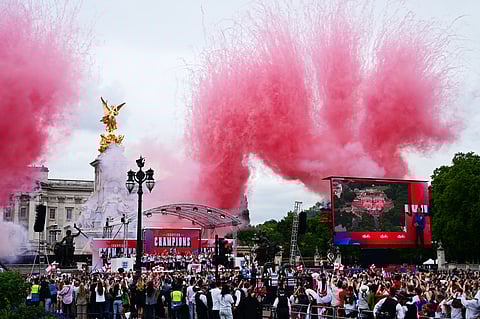 Colourful smoke erupts during the England women's national football team homecoming victory celebration on the Mall outside Buckingham Palace in London on July 29, 2025 to after the team won Euro 2025.