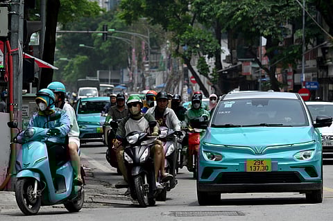 Vinfast electric vehicles are pictured on a street in Hanoi on July 31, 2025.