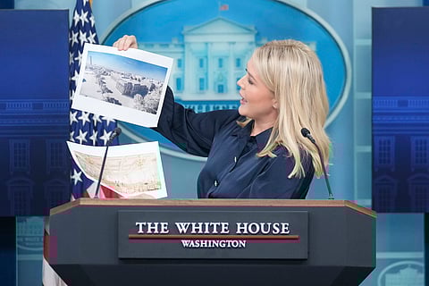 White House press secretary Karoline Leavitt holds up photos of the planned new White House ballroom during a press briefing at the White House in Washington, Thursday, July 31, 2025.